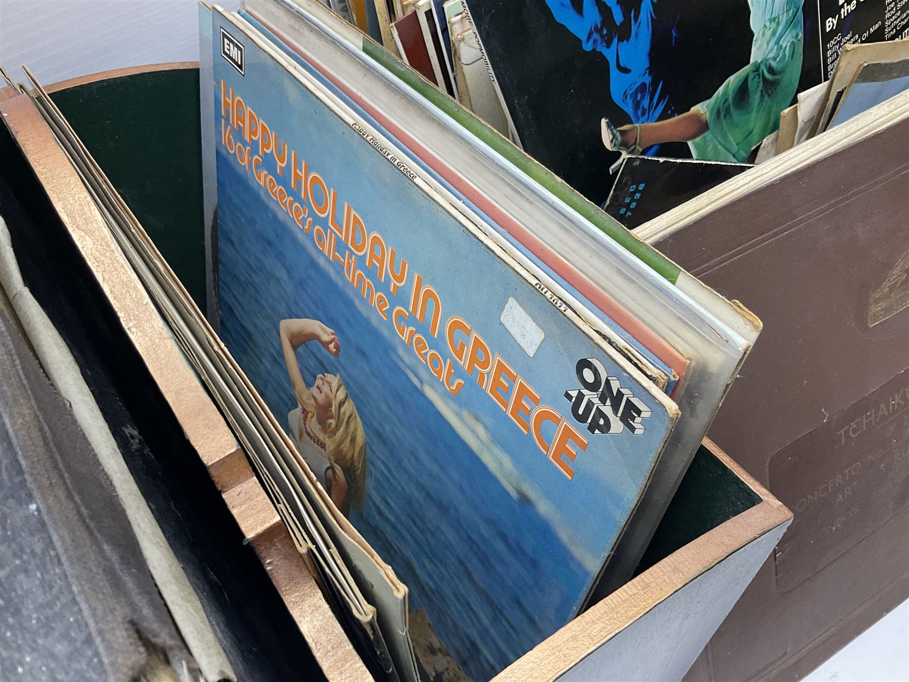 Wooden magazine rack, with floral detail, together with a collection of records, to include the box sets 'the Story of Great Music', 'Popmobility', Happy Holiday in Greece  etc, in three boxes 