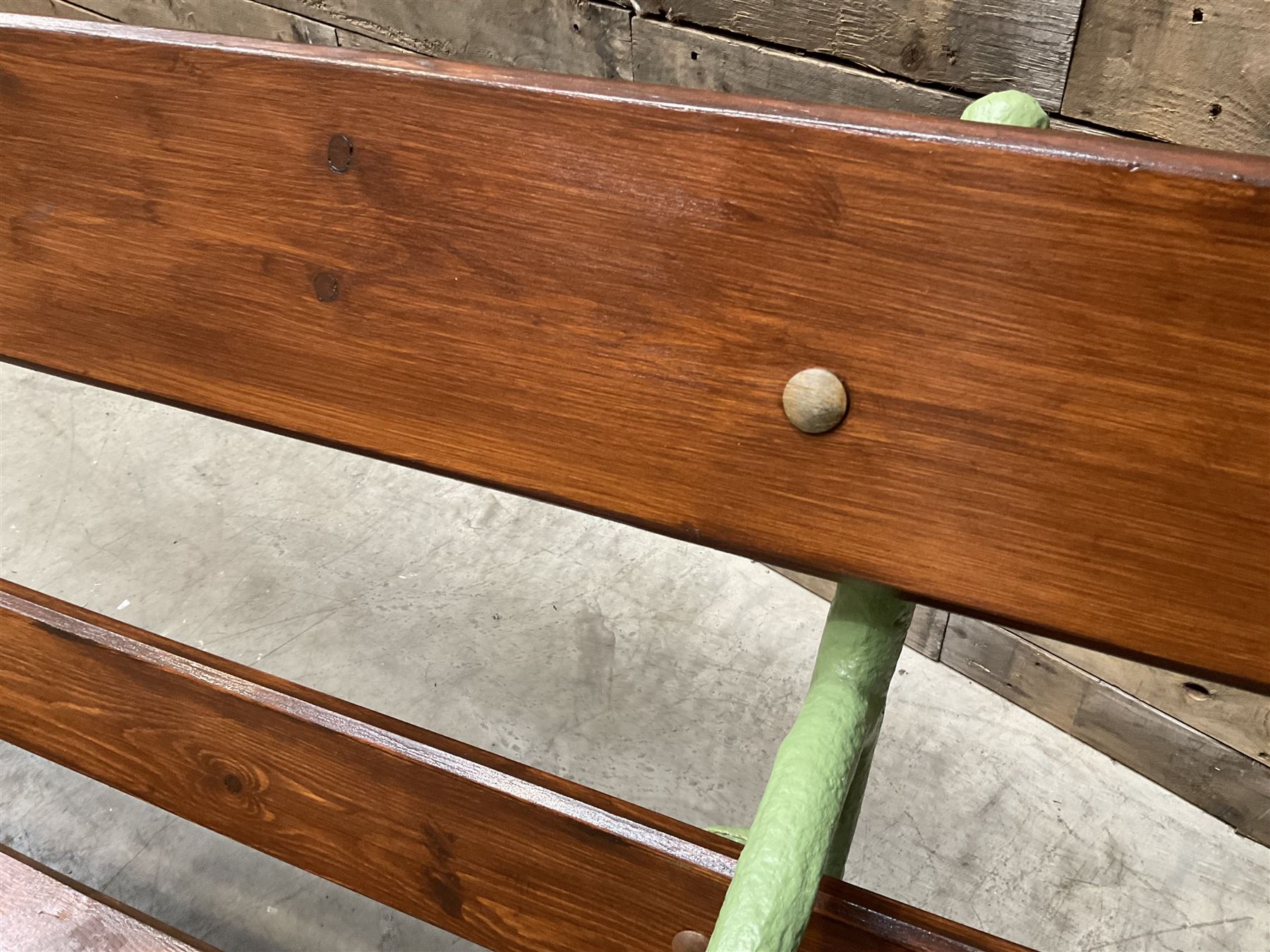 Cast iron and wood slate bench painted in green