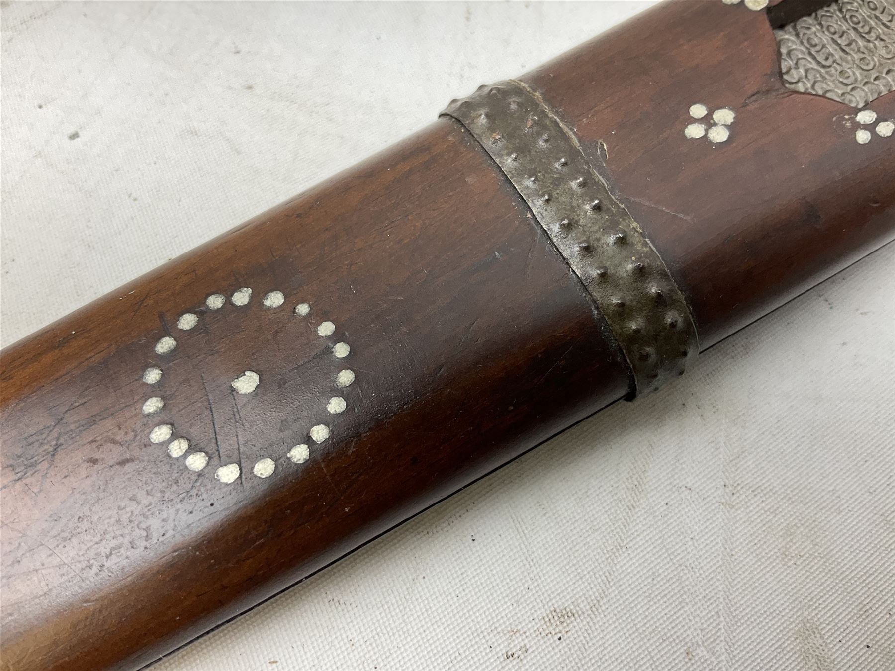 African tribal knife, possibly Shona Zimbabwe, the 22cm steel blade with all over punched decoration and antler handle; in inlaid and banded hardwood scabbard with two apertures L42cm overall