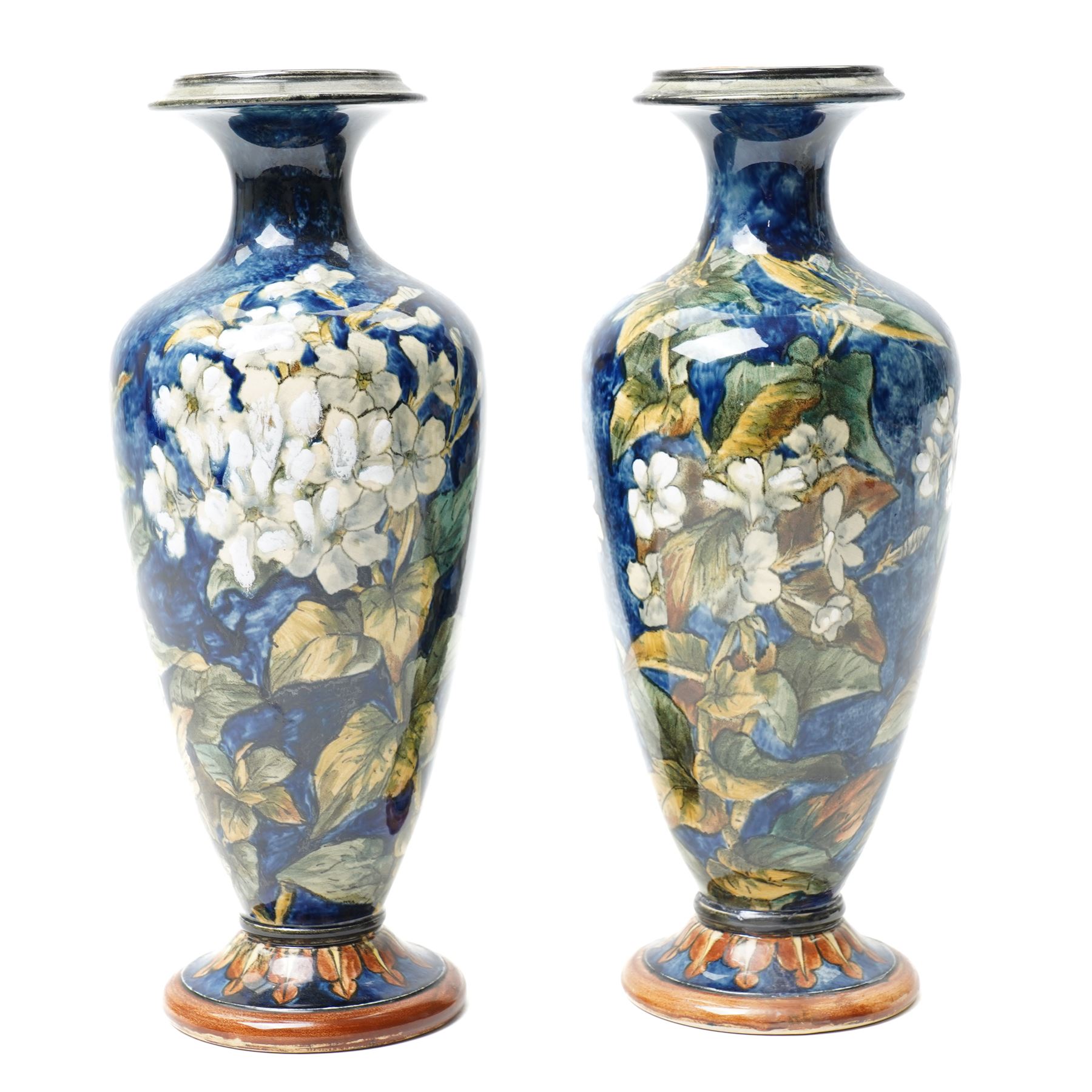 Pair of Doulton Lambeth vases, painted with white flowers, impressed marks to base and signed MA, for Mary Aitken, 1878, H28cm (2)