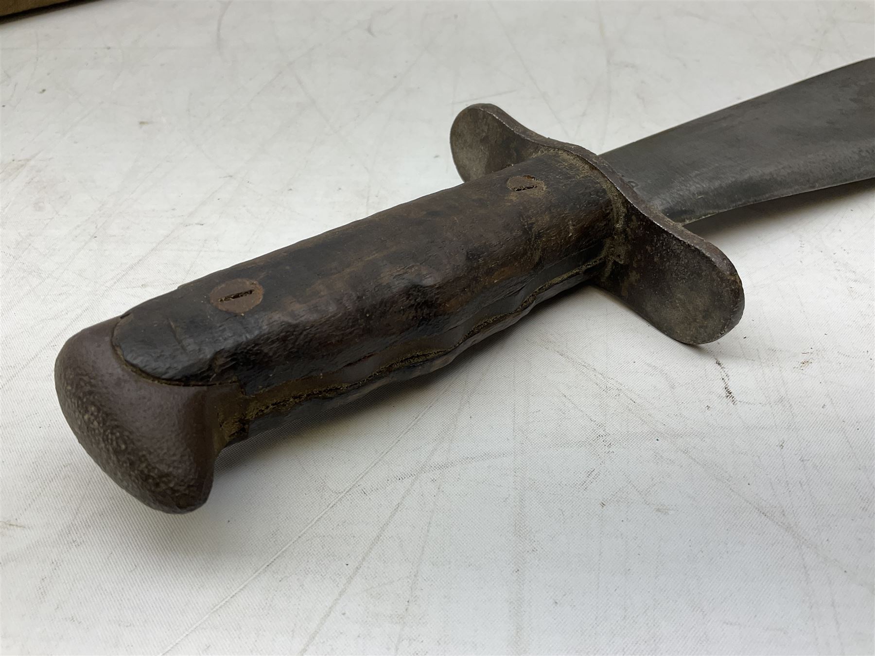 US Model 1910/17  Machine Gunners Bolo knife, the 26.5cm curving steel blade marked 'US MOD 1917 PLUME PHILA 1918'; in webbing covered steel scabbard with leather chape marked 'Brauer Bros 1918' L40.5cm overall (with photocopy of modern reference material)