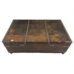 Early 19th century oak low blanket chest, metal strapped and bound, two carrying handles to either end, on castors
