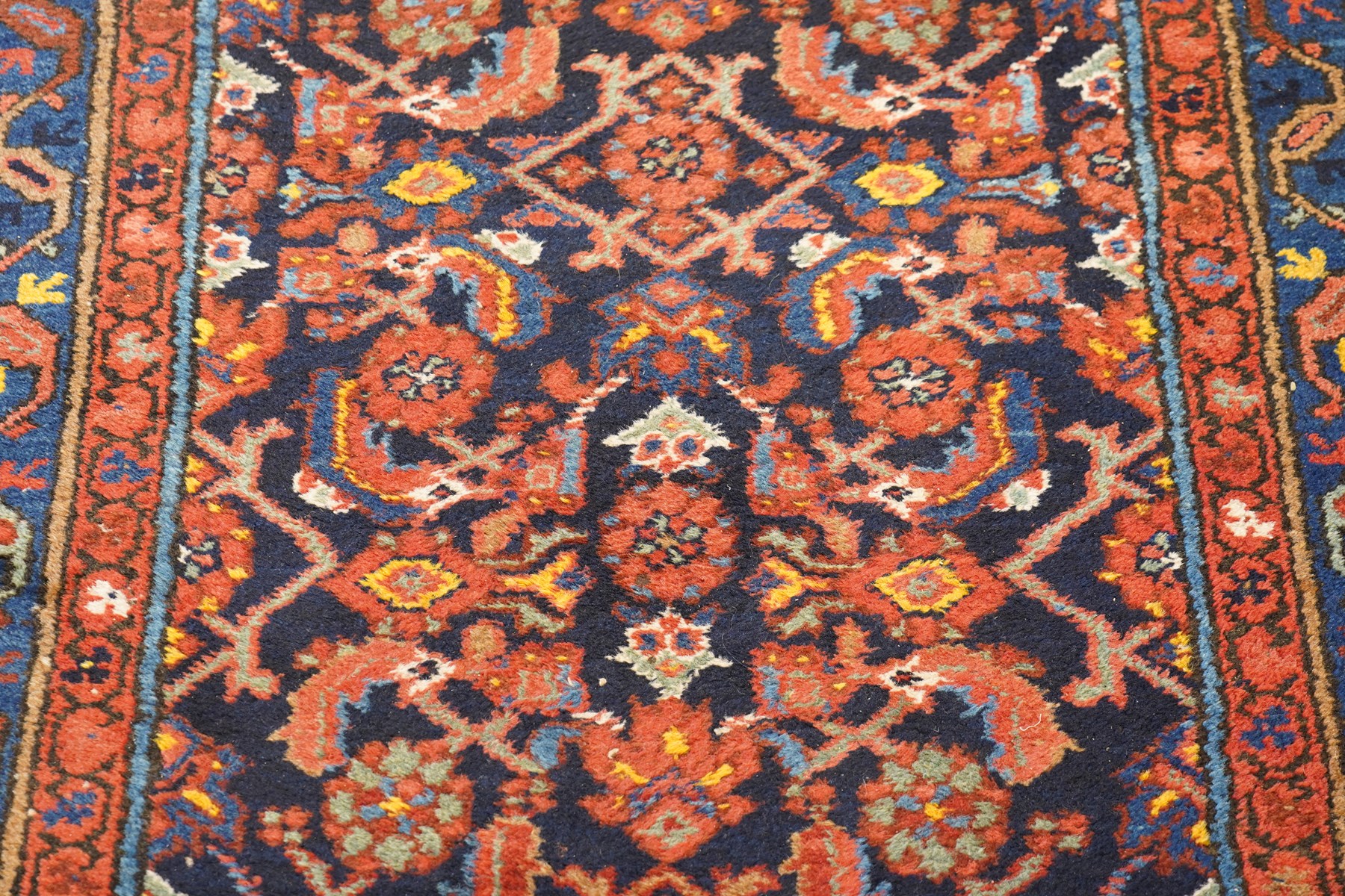 Large vintage Persian Hamadan indigo ground runner rug, the busy field with central ivory medallion and spandrels, surrounded with Herati motifs and stylised plant symbols, with multiple floral decorated guard bands