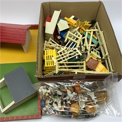Farmyard layout including large walled wooden base board 61 x 45cm with various wooden buildings and plastic accessories, die-cast tractors and farm machinery by Britains, Ertl etc, plastic farm animals and figures by Britains etc