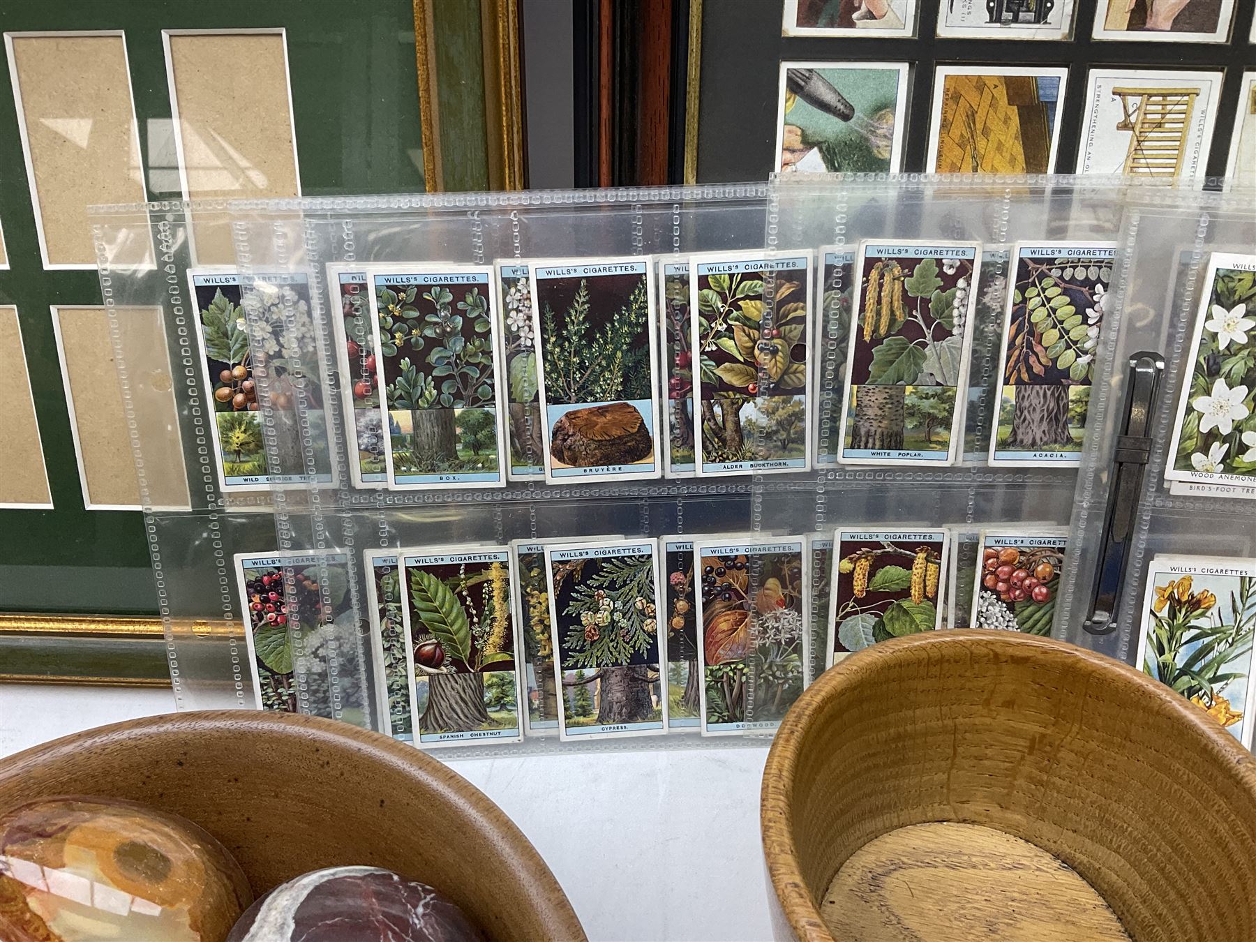 Quantity of cigarette cards to include three frames, and quantity of marble and agate eggs, turned wood bowls etc