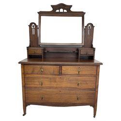 Art Nouveau mahogany dressing chest, arched pierced and carved pediment over raised swing mirror back with bevelled plate, two trinket drawers, base fitted with two short over two long drawers 