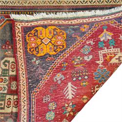 Persian crimson ground rug, decorated with small geometric motifs and animals (158cm x 83cm); together with a Turkish rug (206cm x 119cm)