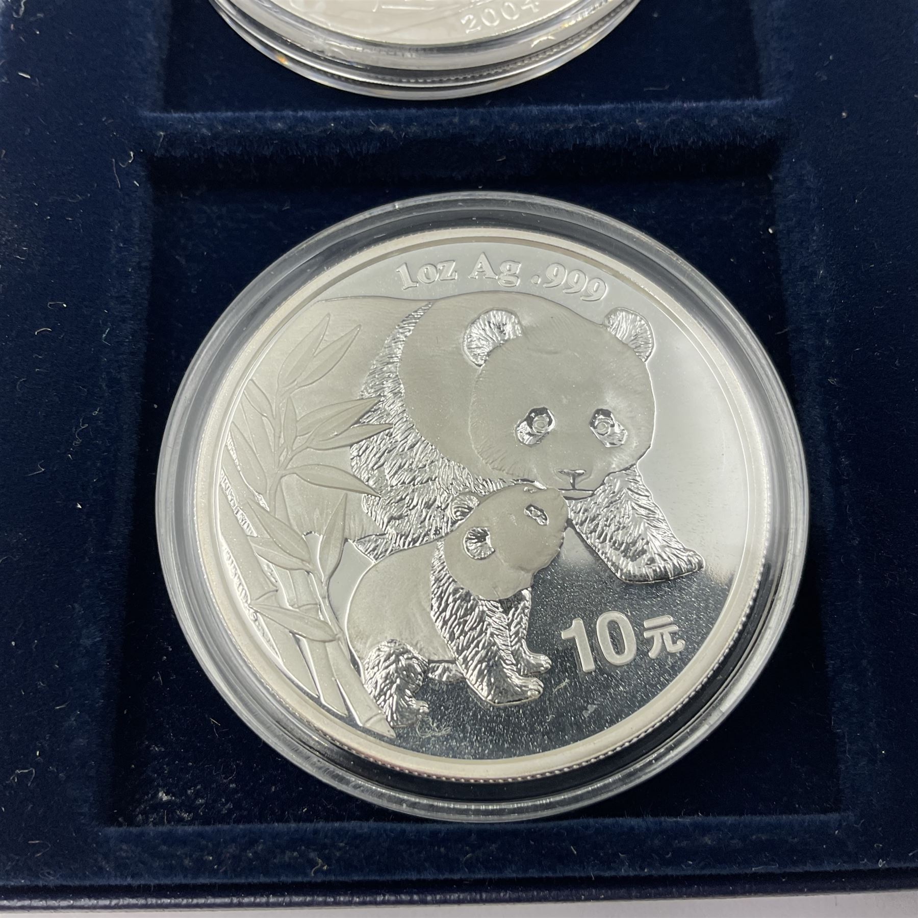Four one ounce fine silver coins, forming 'The 2004 Famous World Silver Coin Collection', comprising United States eagle, Australian kangaroo, Chinese panda and Canadian maple leaf, cased with Westminster certificate 