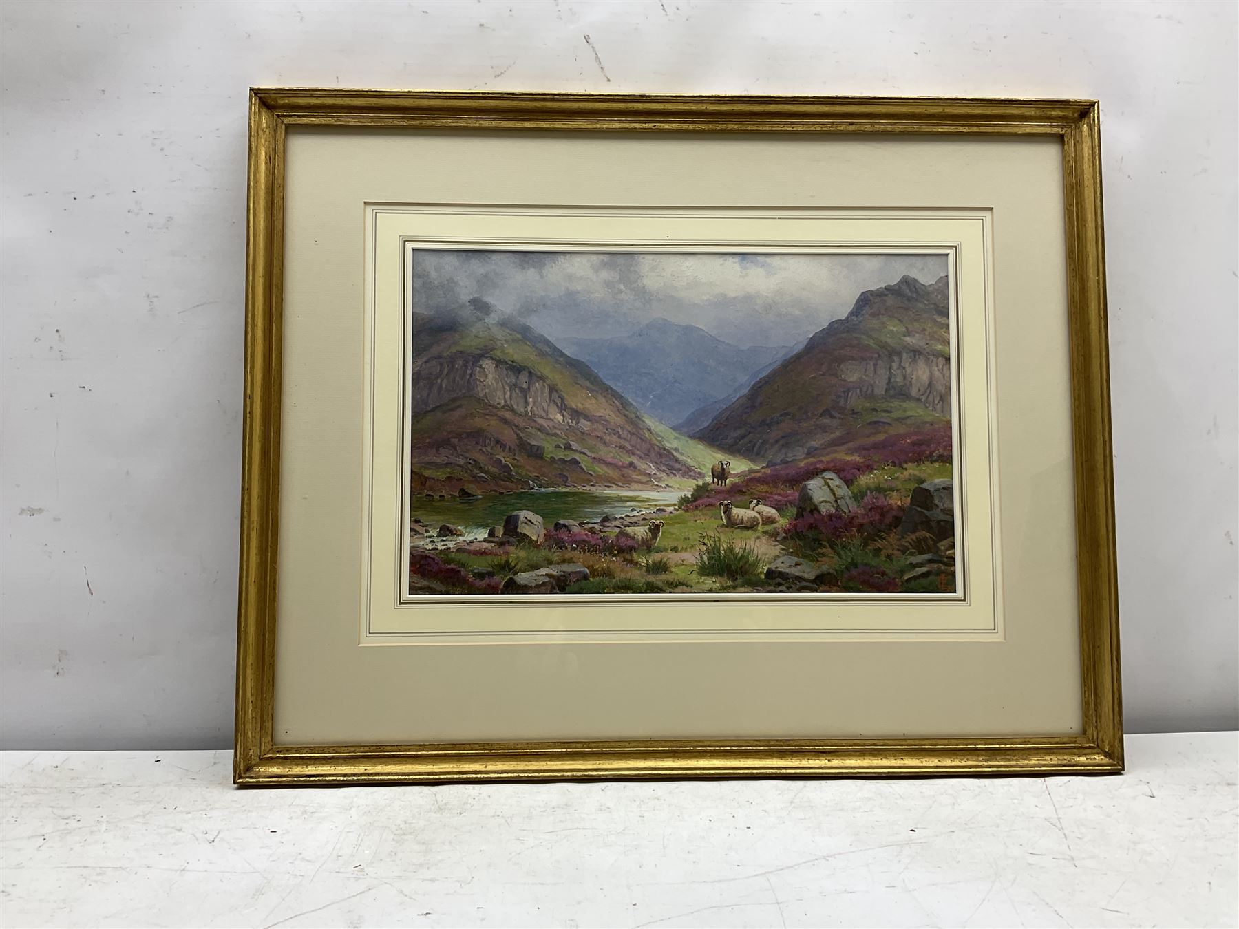 Edgar Longstaffe (British 1852-1933): Highland Cattle and Sheep in Mountain Landscapes, pair watercolours and gouache signed with monograms 23.5cm x 37cm (2)