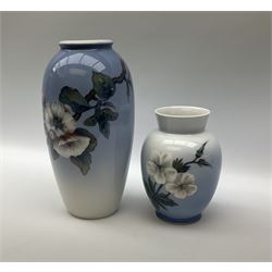 Two Royal Copenhagen vases, first example a vase of baluster form with apple blossom design on a pale blue ground, model no 2629 design no 2129 H27.5cm, second example a vase of ovoid form, with flower and butterfly decoration, model no 2667 design no 36 H17.5cm. 