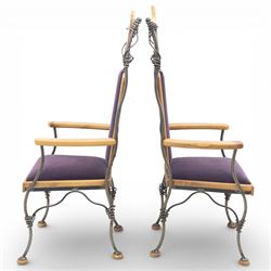 Paul Hodgkiss Designs of Glasgow - contemporary shaped elm dining table with wrought iron base; with set ten (8+2) matching high-back dining chairs, table of organic form above an elaborate wrought iron supports, with central elm stretcher, the chairs with en suite with matching wrought iron work burred elm headrest, purple velour upholstery with drop in seat     

Table: W 102cm, L 243cm, H 74cm
Chairs: W 56cm, D 52cm, H 130cm