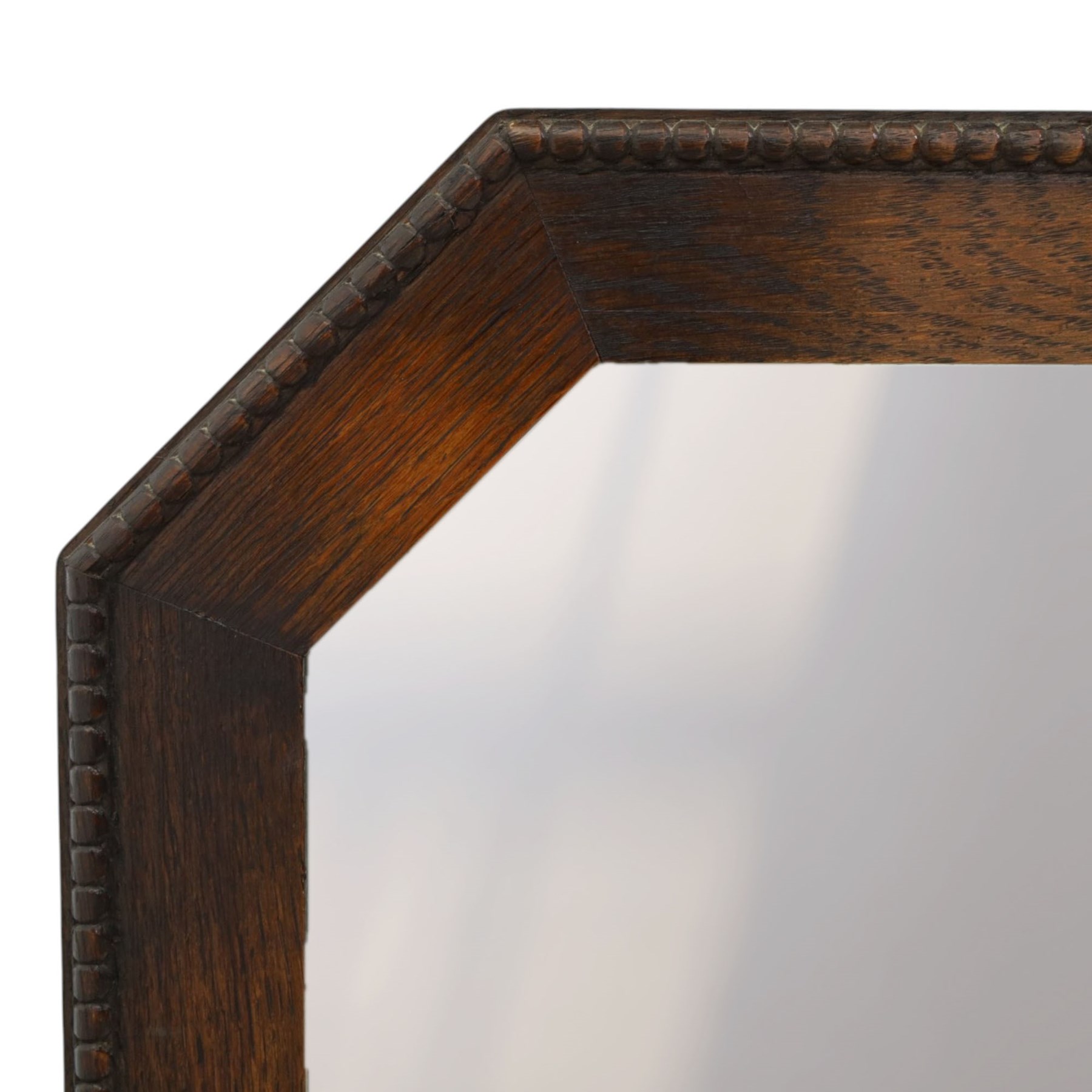 Early 20th century oak wall mirror, canted rectangular frame with bevelled plate 