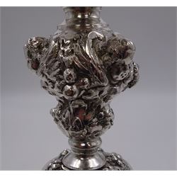 German silver chalice, the bowl, stem and foot each with 19th century repousse and chased decoration depicting putti masks, C scrolls and flowers, set with two hand painted porcelain roundels, possibly Berlin, and six later applied enamel roundels, each depicting religious scenes, the gilded bowl upon knopped stem and spreading octofoil foot, the base with marks for Munich, c.1695 and maker's mark FK