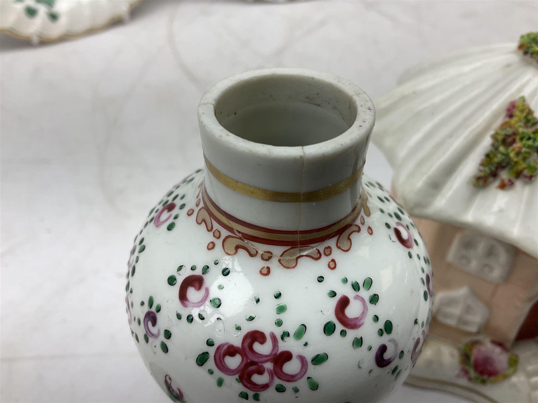 Mid 18th century Chelsea plate with gold anchor mark beneath, decorated with green floral sprays upon plain ground, the moulded cavetto shaped border with gilt rim, (A/F), D22cm, together with early 20th century Adams Tunstall Tokio pearlware slop bowl, Spode plate decorated in the Imari type pallette, with impressed and printed marks beneath, 19th century Indian Tree pattern breakfast cup and saucer, small polychrome enamelled vase and cover in the style of Samson of Paris, with marks beneath, and a pastille burner