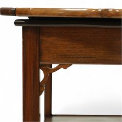 20th century mahogany butler’s tray on stand, with folding gallery tray top featuring shaped hand grips and brass hinges, fitted with single drawer and lower shelf, on square section legs with pierced brackets and castors