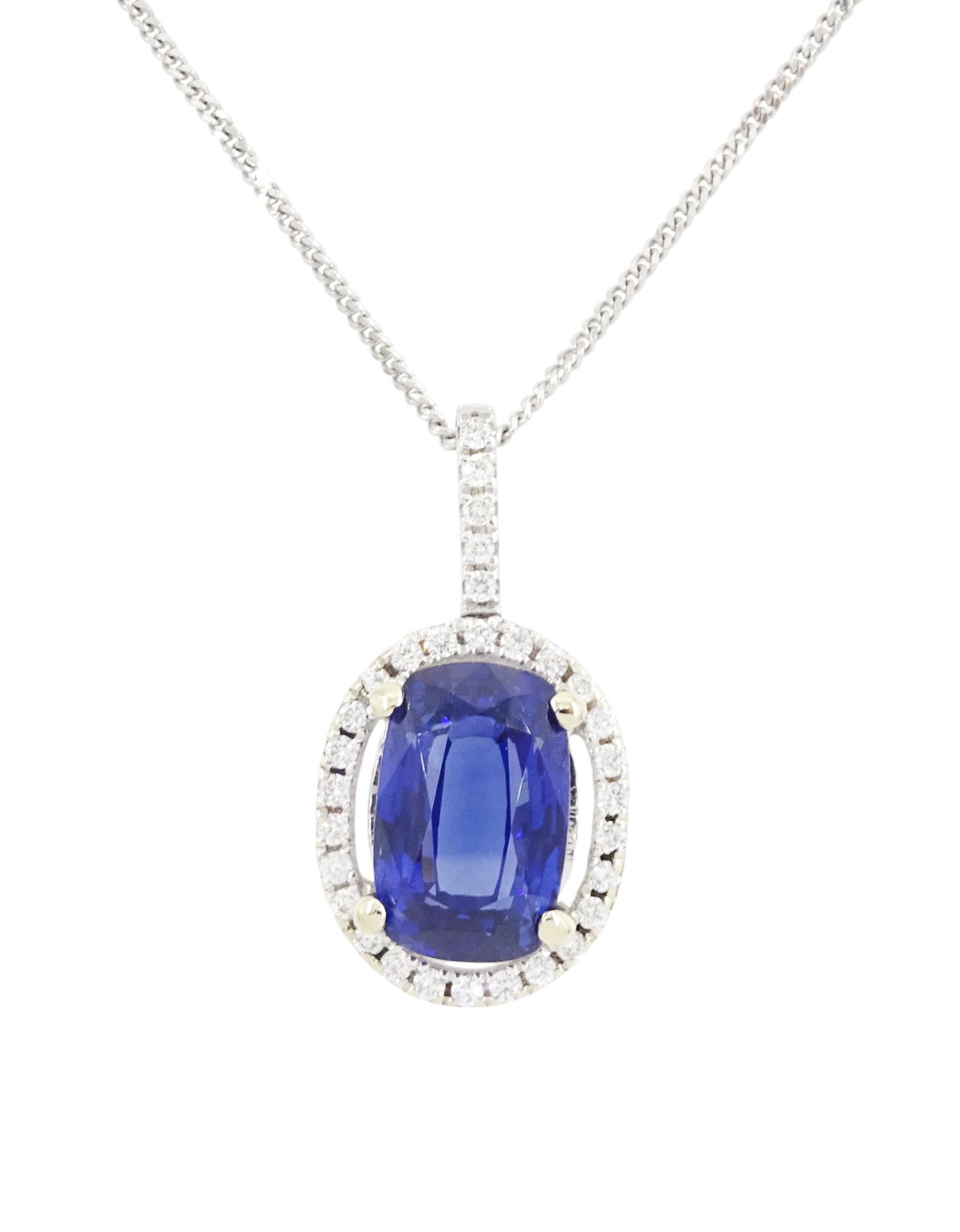 18ct white gold sapphire and diamond halo pendant necklace, single cushion cut sapphire of approx 4.65 carat, with round brilliant cut diamond surround and bail, on fine flattened curb link chain necklace, both hallmarked, total diamond weight approx 0.35 carat
