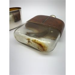 A large glass hip flask with silver plated removable base/cup, silver plated screw threaded cover, and leather clad upper section, H7.5cm. 