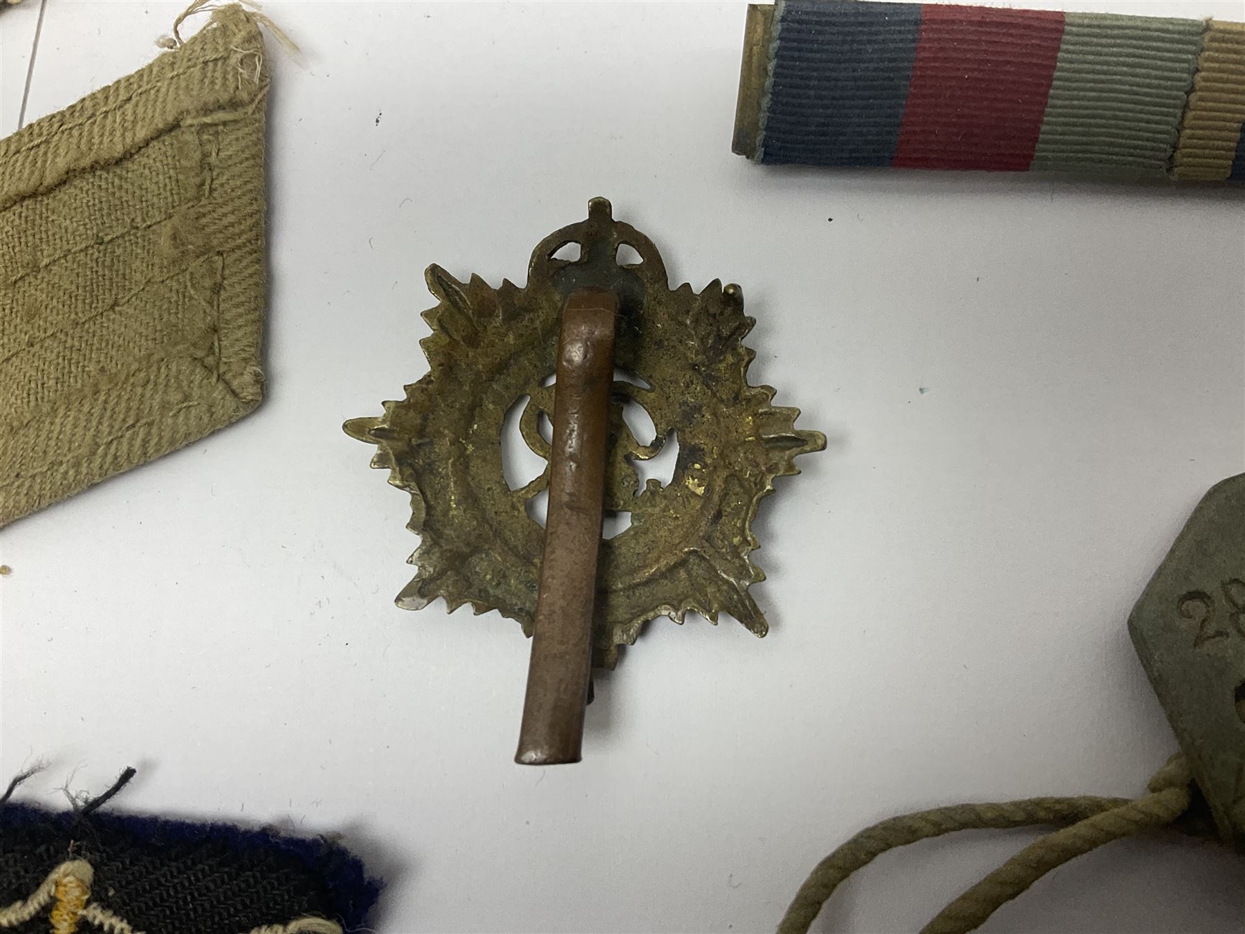 WWII group of three medals comprising 1939-45 War Medal and Italy and Africa Stars in issue box; dog tags for 282894 W. Wilkinson with framed photograph in uniform; and small quantity of cloth and metal badges including RAOC cap badge