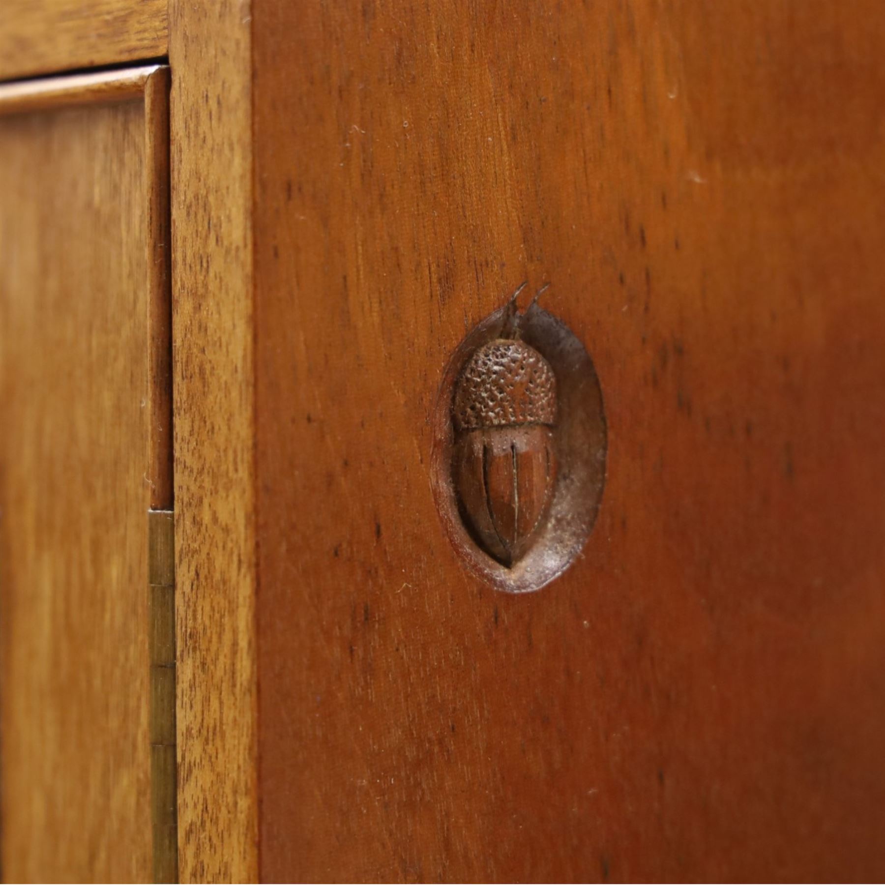 Acornman - mahogany sideboard, rectangular top over four drawers and four panelled cupboard doors with brass handles, on bracket feet, with signature carved acorn, by the workshop of Alan Grainger of Brandsby