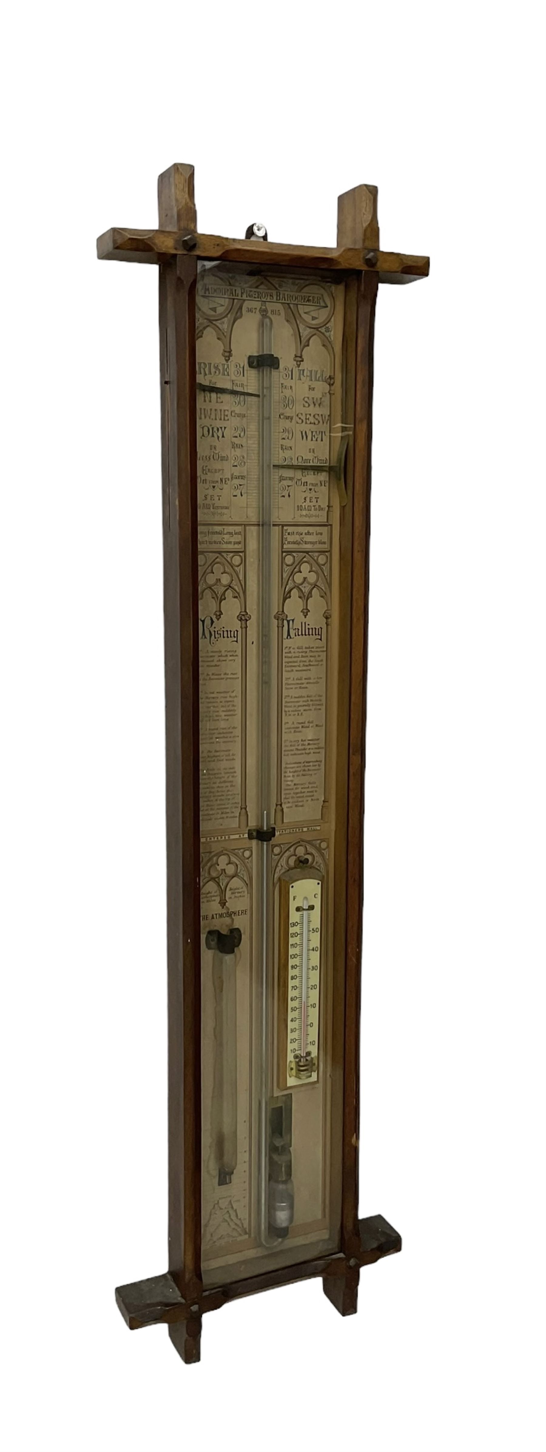 Oak cased Admiral Fitzroy barometer c1890 - with original full height paper scales annotated with Fitzroy's remarks and observations, brass sliding pointers above a Fahrenheit and centigrade spirit thermometer and storm glass, large bore bulb cistern tube with a mechanical sealing tap, in a fully glazed reformed gothic influenced case with chamfered moulded uprights, top, and base.