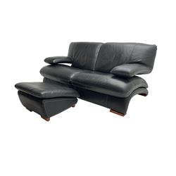 Two seat sofa, upholstered in black leather with white stitching, with matching footstool
