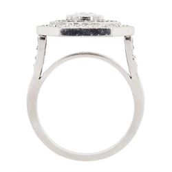 Platinum diamond and sapphire hexagonal ring, the principle diamond of approx 0.55 carat, with sapphire and round brilliant cut diamond surround, all milgrain set, hallmarked