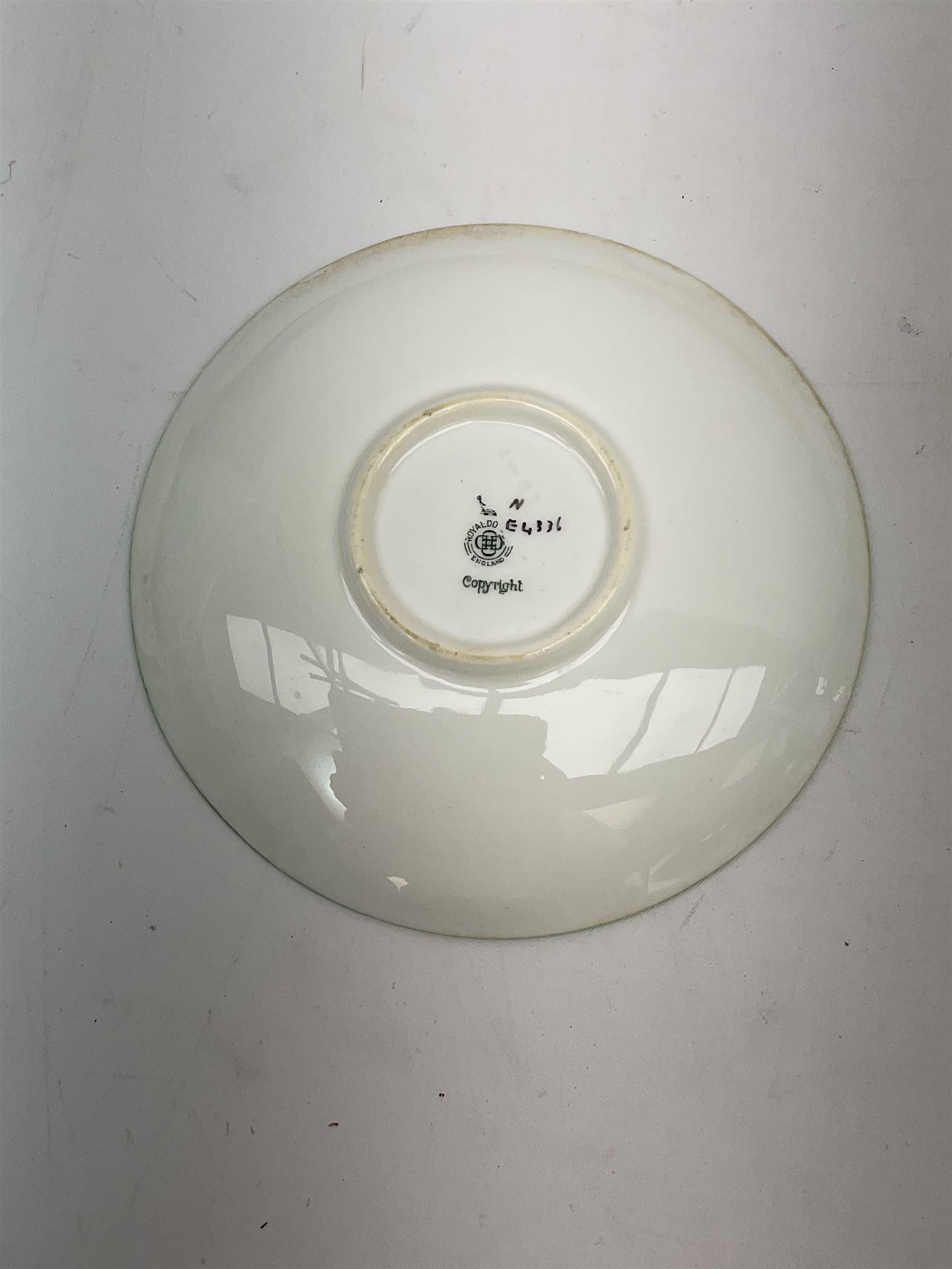 Early 20th century Royal Doulton teacup and saucer, from the series 'The All Black Team', the teacup depicting a cricketer entitled 'Good for fifty', the saucer depicting a cricketer stood in a long coat and wide brimmed hat, entitled 'The Boss', both with printed mark beneath, cup H6.5cm