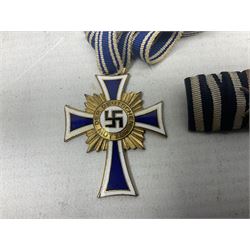 German tunic two-medal ribbon bar for WW1 Iron Cross and Long Service Medal; together with  WW2 German Mothers Cross 'Mutterehrenkreuz' 1st Class gilt with ribbon, inscribed verso 16 Dezember 1938 with Hitlers facsimile signature (2)
