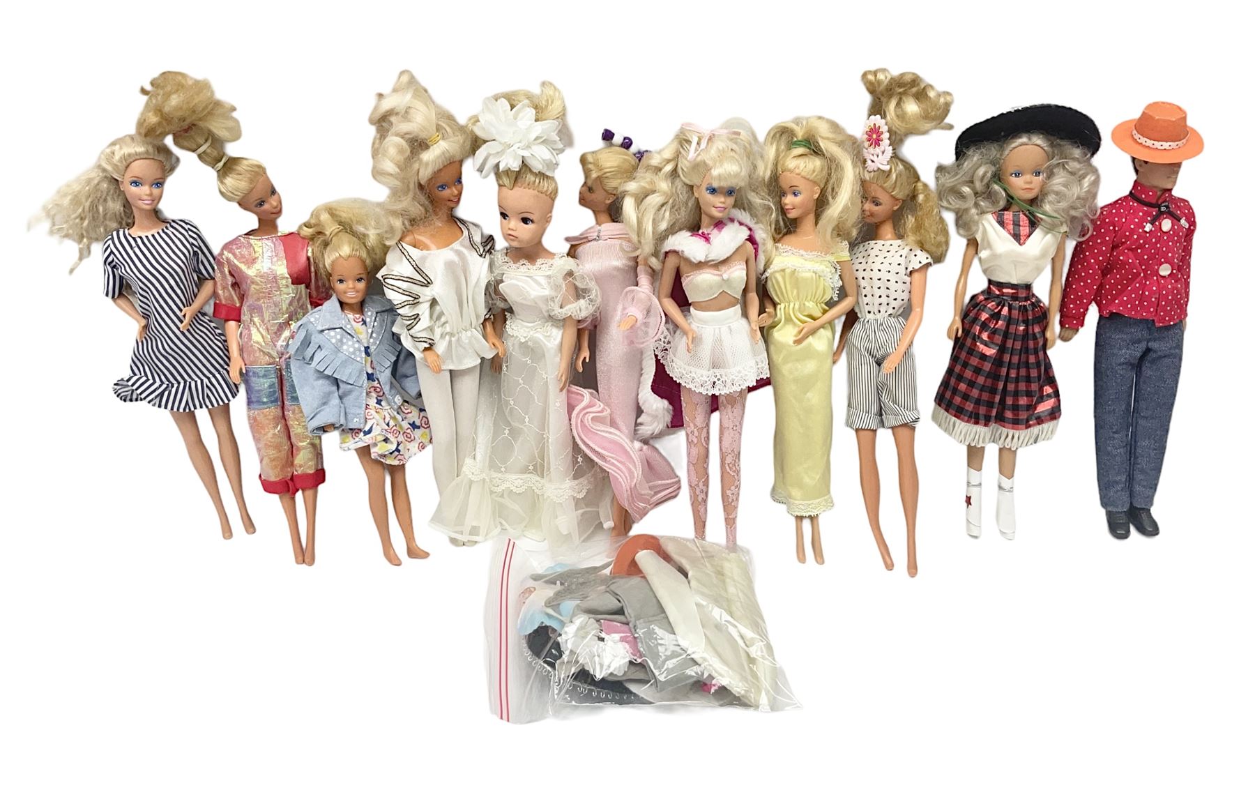 Eleven 1980s fashion dolls, predominantly Barbie/Ken, all dressed; together with some additional clothing.