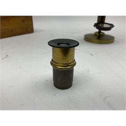Victorian lacquered brass monocular microscope on circular base with ball and socket adjustment and screw action rise-and-fall focusing H28cm; in fitted walnut case with additional lens and small quantity of glass slides