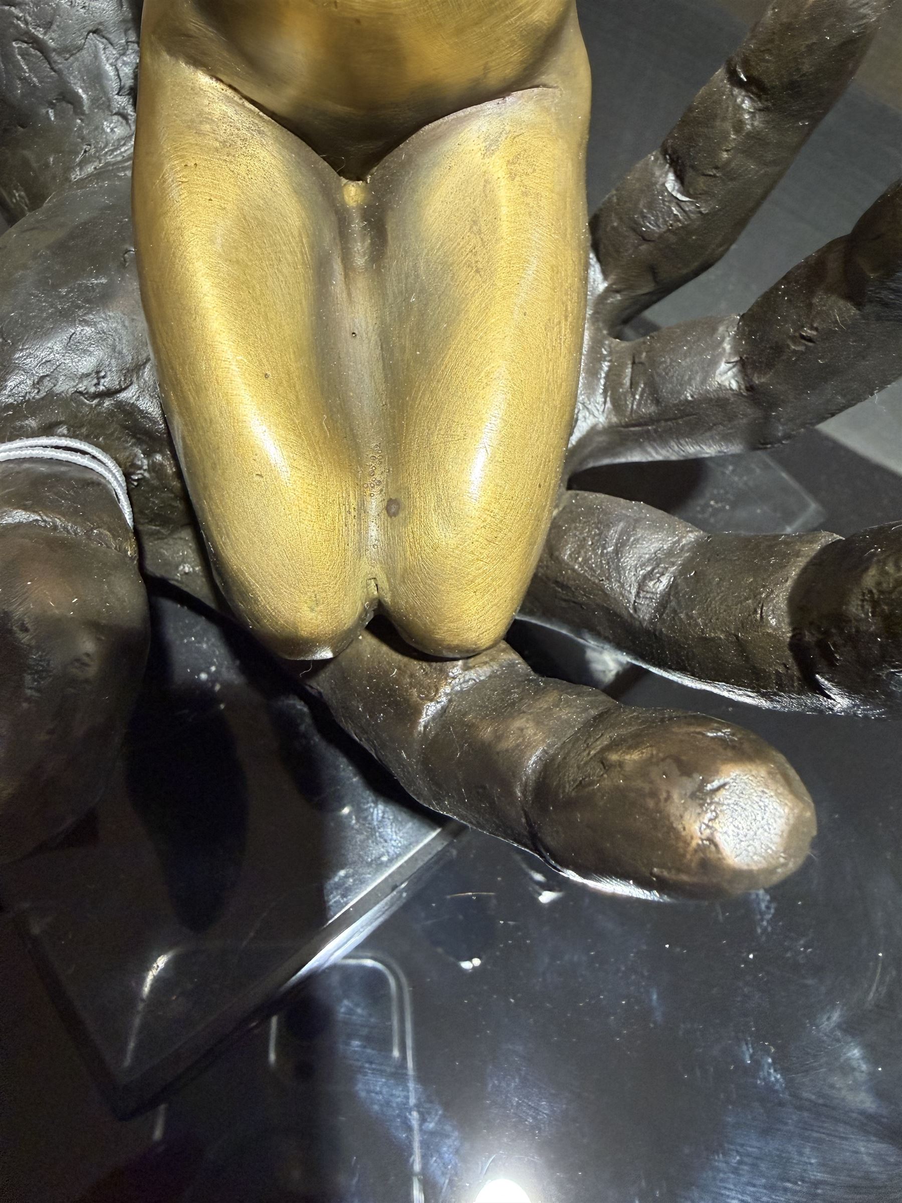 Nude In Hand bronze sculpture modeled as a female nude seated in a hand upon a marble base, signed June H24cm   