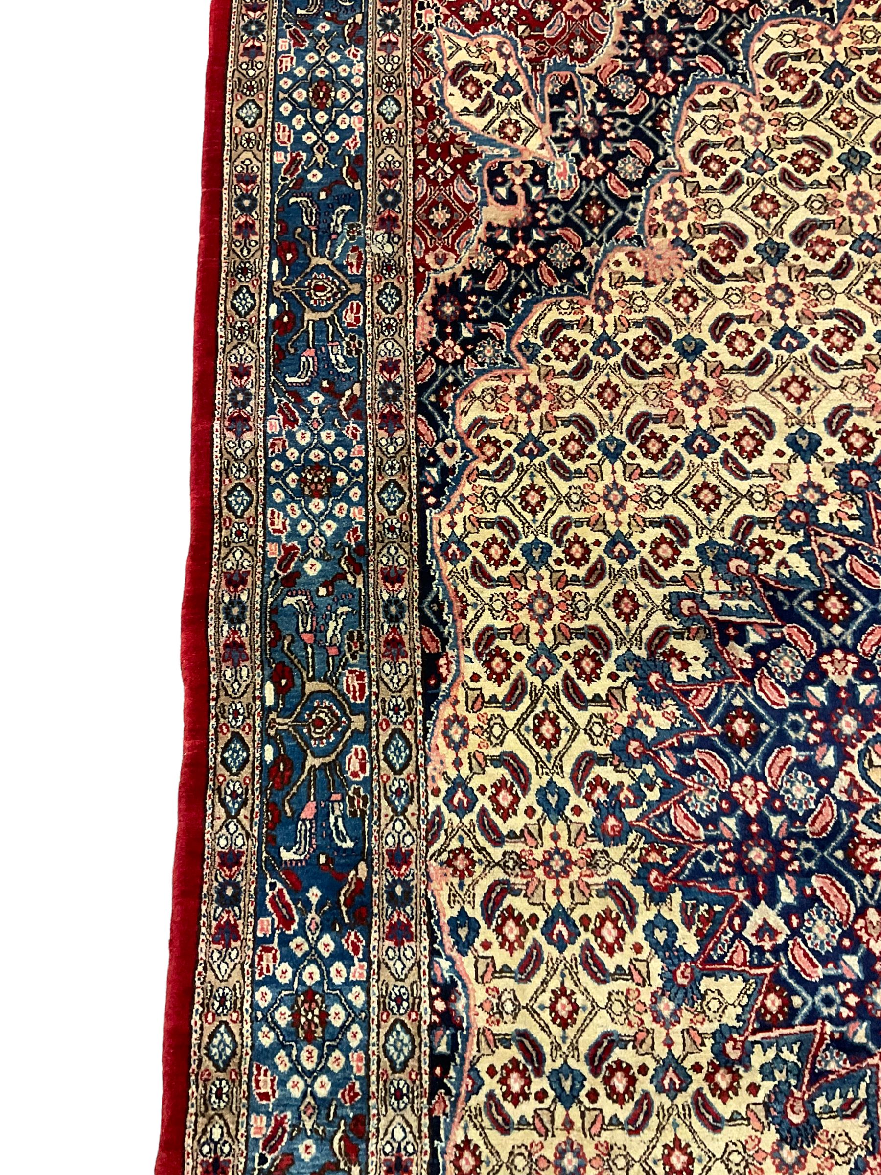 Persian Moud carpet, the field decorated all-over with Herati motifs, central medallion and spandrels decorated with stylised plant and flower head motifs, repeating border with guard