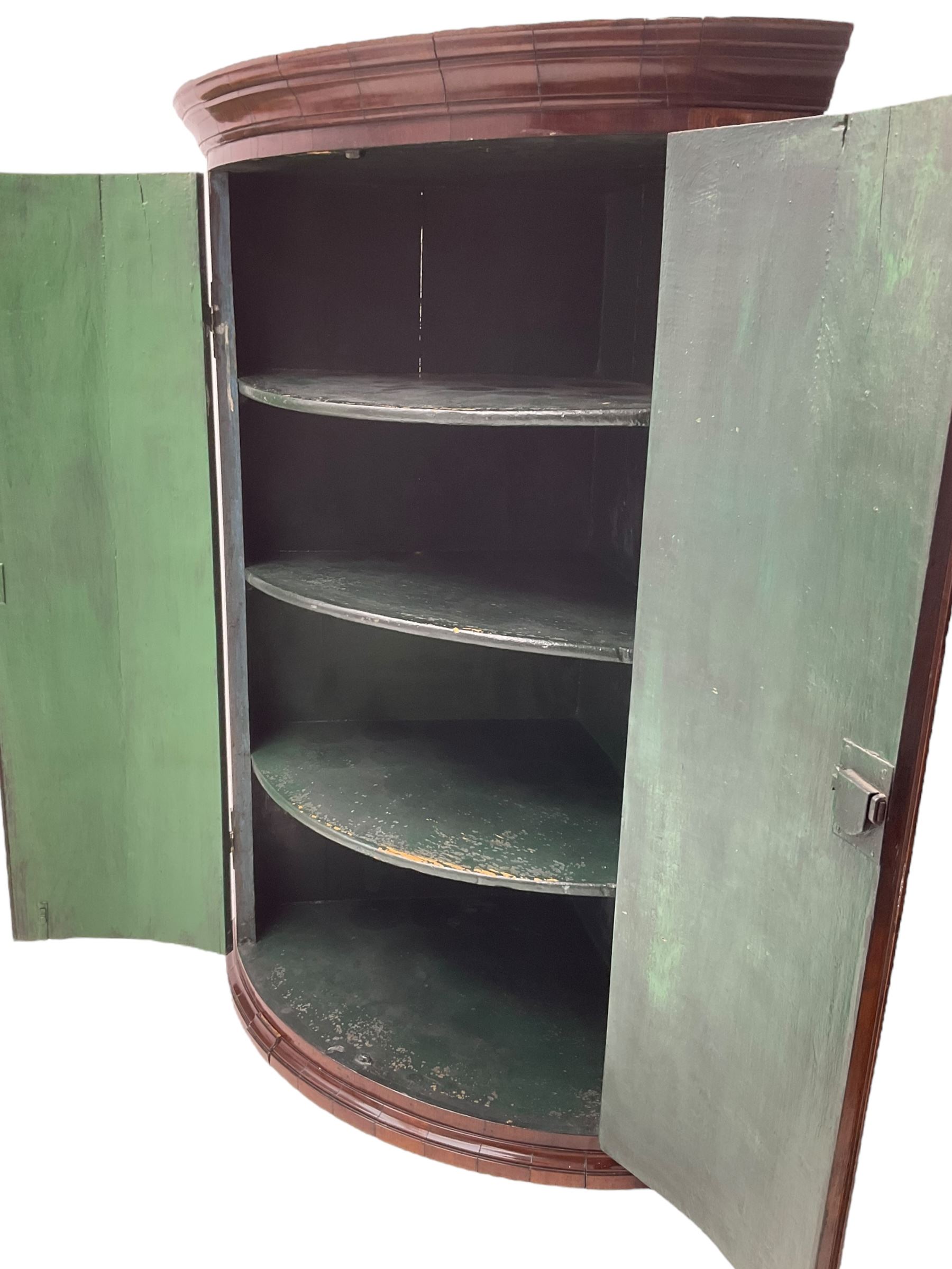 George III oak and mahogany wall hanging cylinder corner cupboard, moulded cavetto cornice over double cupboard enclosing three shelves