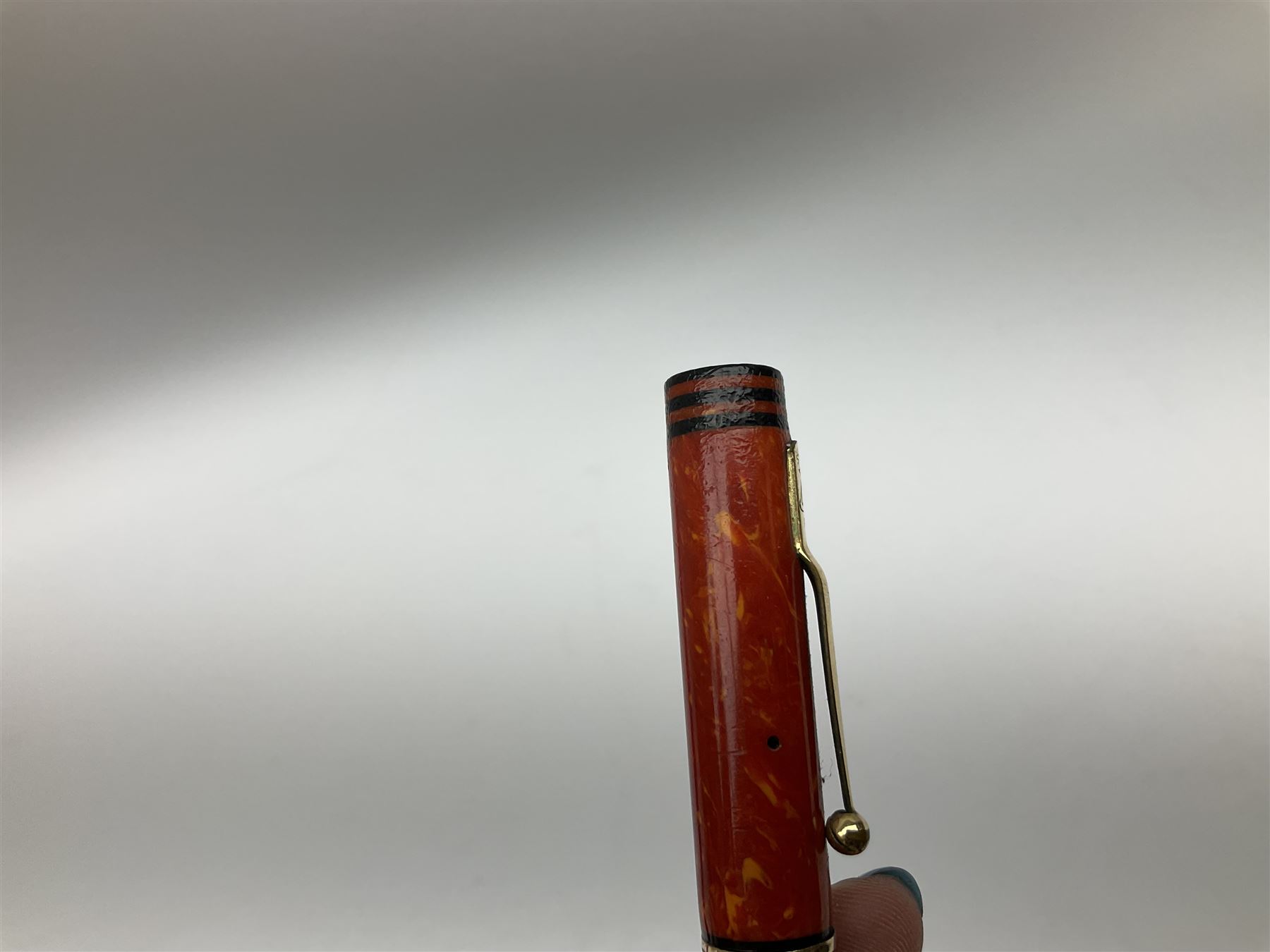 Vintage Swan Mabie Todd lever fill fountain pen in coral red, the nib a/f marked 14K, together with two further vintage Swan Mabie Todd fountain pens, the first example with lever fill, the other leverless, each with black body, one with nib marked 14ct, (3) 