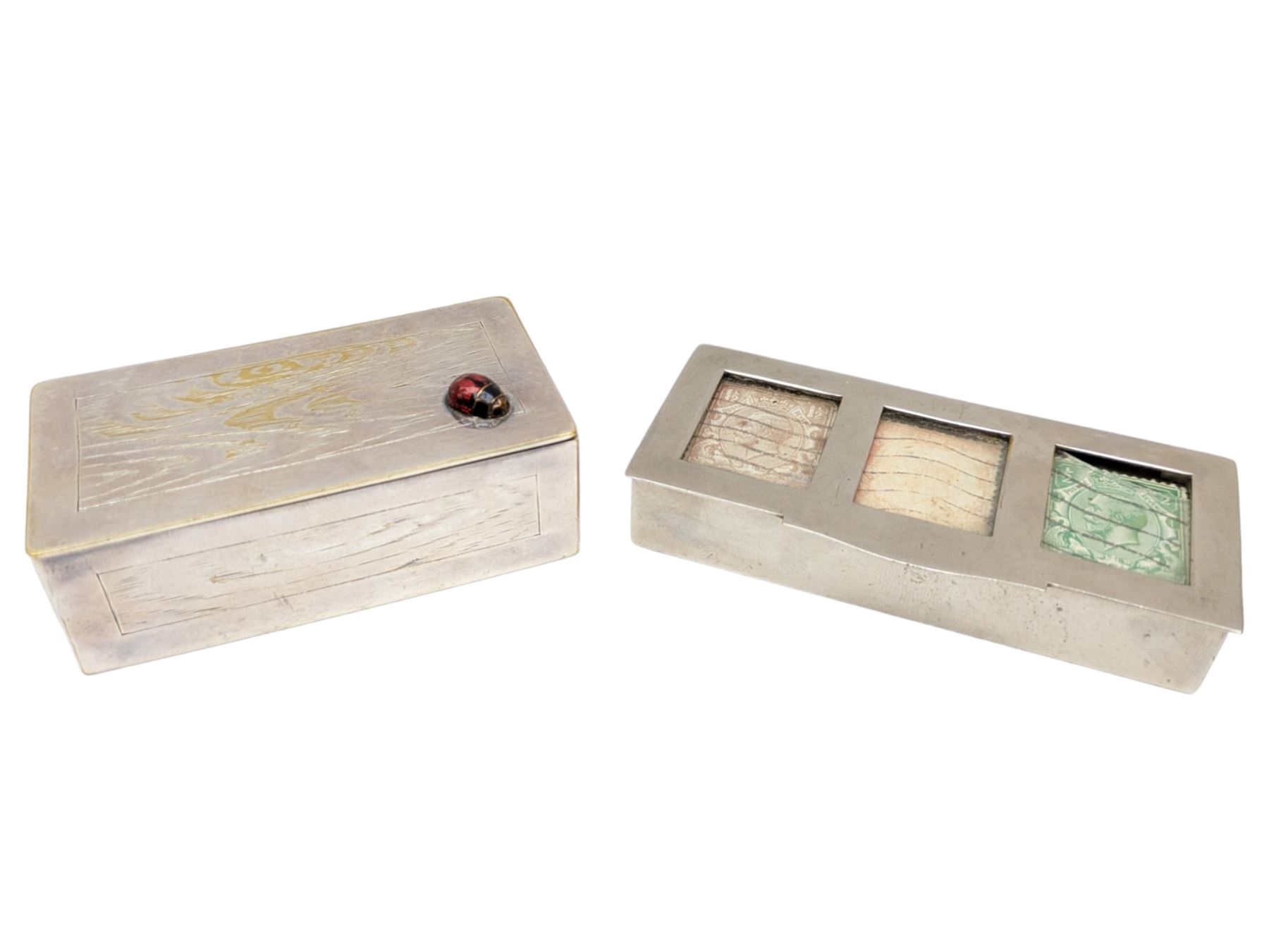 Two three division stamp boxes, the first with enamelled ladybird decoration and engraved initials to the inside of the hinged cover, the second with glass cover showing three King George V stamps