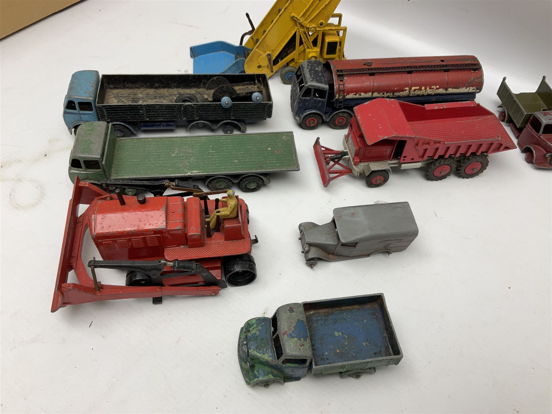 Dinky - twenty-six unboxed and playworn die-cast models including Foden Regent Tanker, two Foden lorries, Pressure Refueller No.642, Snow Plough, Elevator Loader, Foden Dump Truck, Blaw Knox Bulldozer and other commercial vehicles