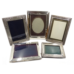  Three hallmarked silver mounted freestanding rectangular photograph frames and two white metal frames  