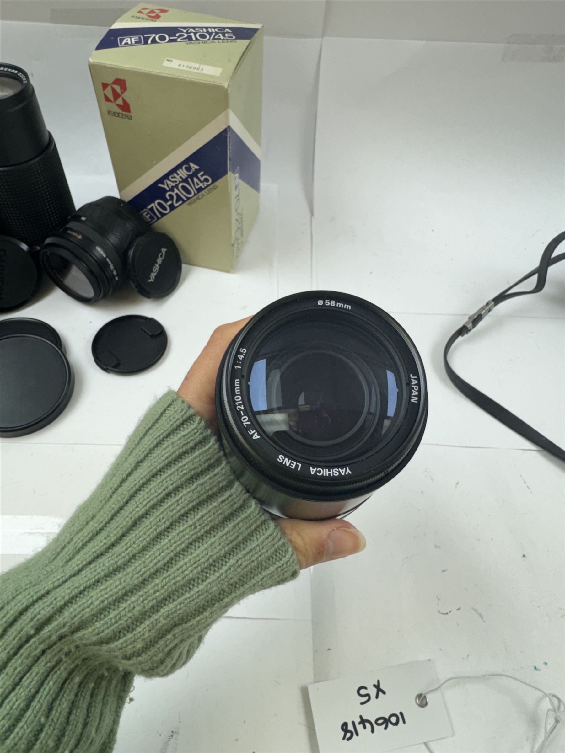 Group of camera lenses, comprising Yashica AF 70-210mm 1:4.5 58mm lens serial no. F6106983, boxed, Yashica AF 35-70mm 1:3.3-4.5 52mm Macro lens serial no. F60231147, Yashikor Aux Wide Angle 1:4 lens and a Yashikor Aux Tele-Photo 1:4 lens, Mamiya-Sekor E 1:2.8 f=28mm serial no. 13427 and a Mamiya-Sekor Zoom E 1:4 f=80-200mm lens serial no. 11271