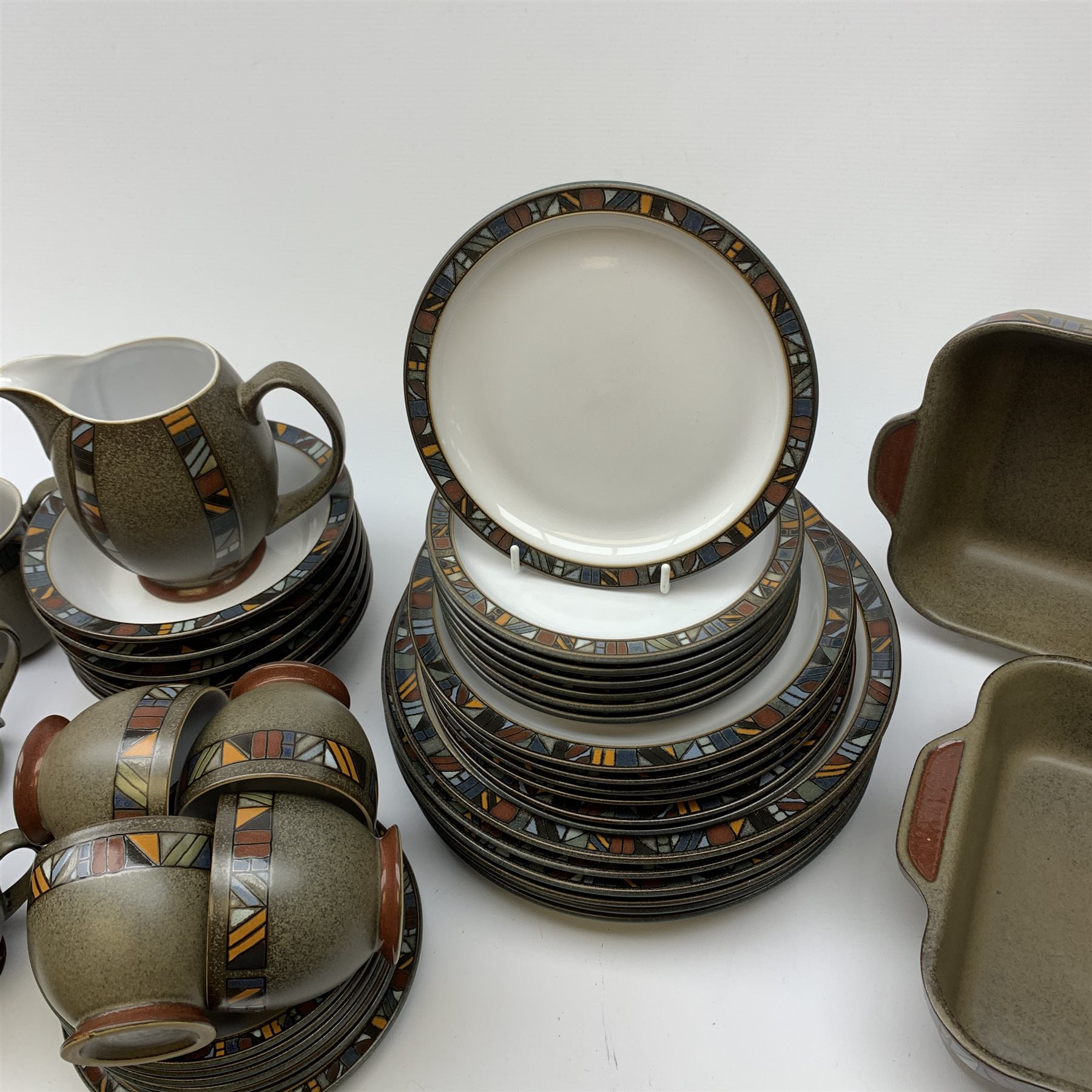A Denby Marrakesh pattern dinner service, comprising six dinner plates, six dessert plates, seven side plates, two serving dishes, six bowls. six tea cups, six saucers, six coffee mugs, milk jug and saucer.
