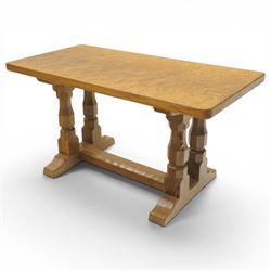 Mouseman - adzed oak rectangular coffee table, commissioned with four octagonal supports joined by chamfered stretcher terminating in sled feet, with carved mouse signature, by the workshop of Robert Thompson of Kilburn