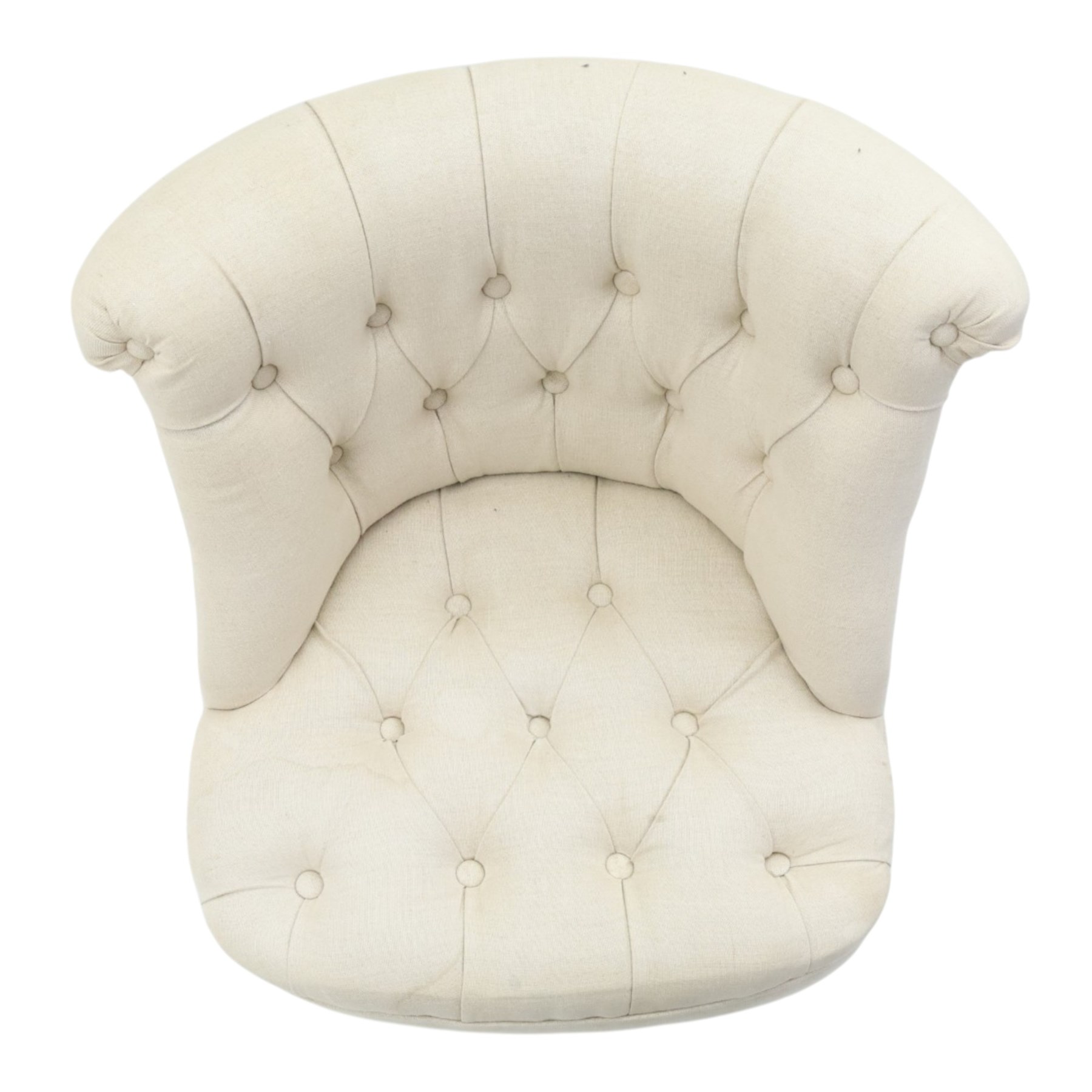 Victorian style upholstered tub chair, buttoned cream fabric back and seat with rolled sides, on ebonised turned front supports with brass castors and splayed rear supports