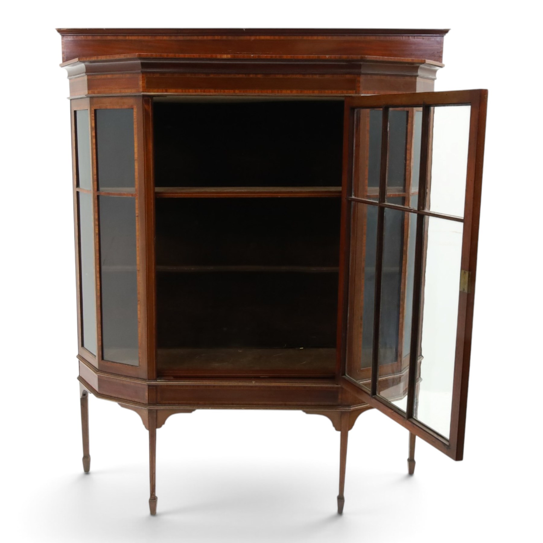 Edwardian inlaid mahogany display cabinet of rectangular canted form, galleried top with crossbanded inlay, above a glazed cabinet enclosing  baize lined shelves, raised on square tapering legs terminating in spade feet  