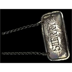 Three silver decanter labels and a collection of silver and silver plated cutlery