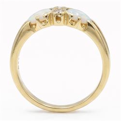 18ct gold opal and diamond four stone ring, two round brilliant cut diamonds, with a single cabochon pear cut opal set either side, London 1994