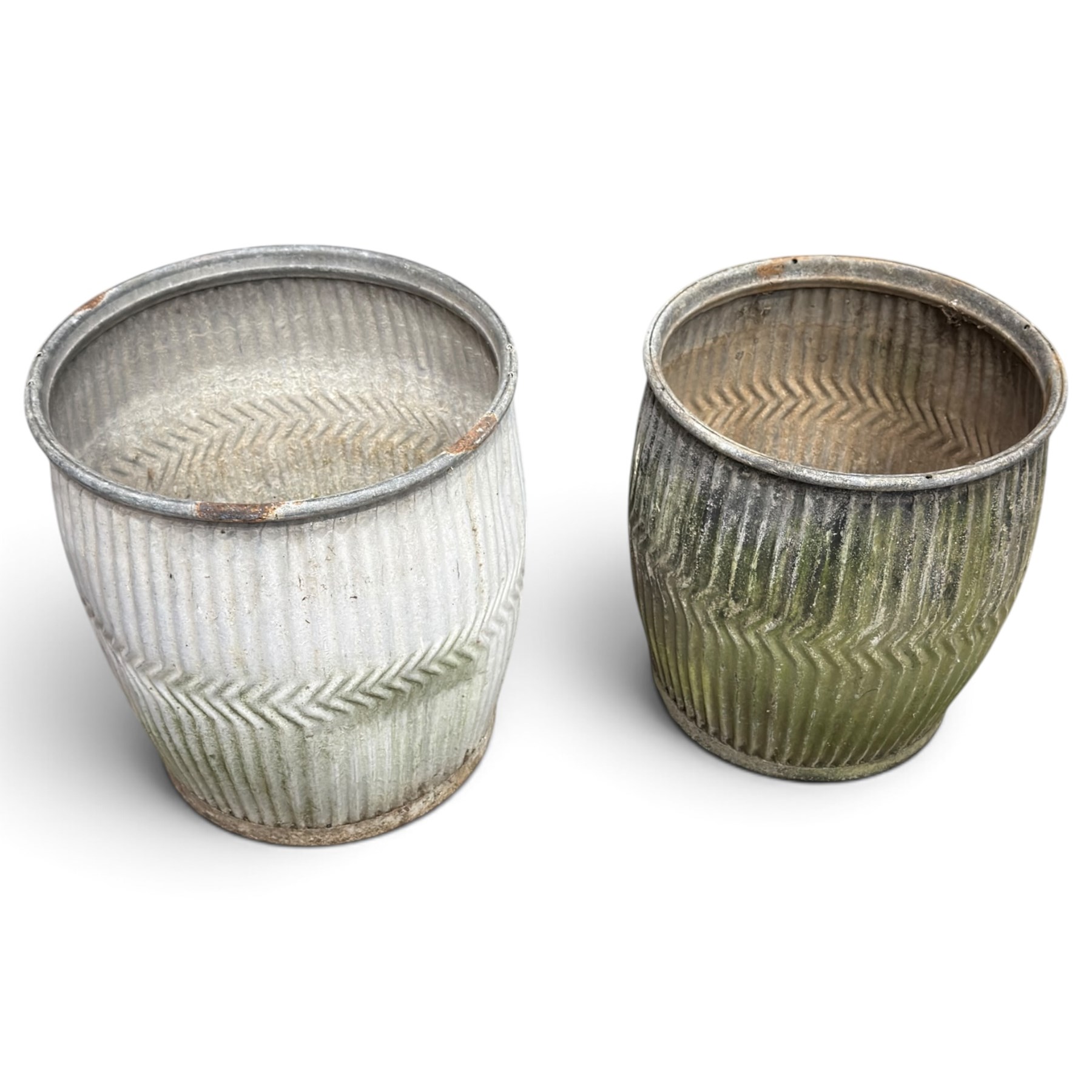Two20th century galvanised metal dolly tubs, with rolled rims above corrugated bodies centred by chevron bands and circular bases, max W48cm H52cm)