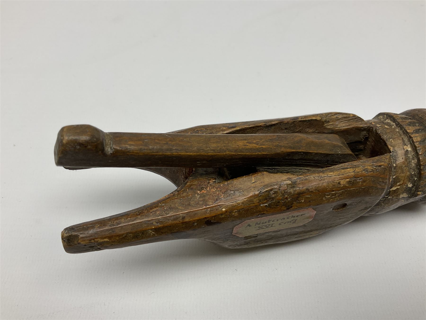 Rare primitive treen lever action nutcracker, probably late 17th/early 18th century, carved in the form of a man, with old collector label to side inscribed 'A Nutcracker XVI Century', H18cm