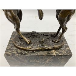 Bronze figure group, modelled as two male hares boxing, upon a naturalistic base after 'Nick' and with foundry mark, raised upon a rectangular base, H24cm