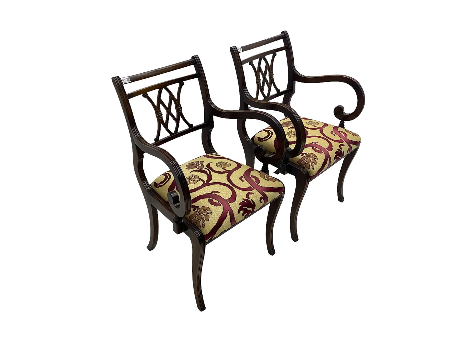 Regency design mahogany twin pedestal dining table, rectangular top with reeded edge, acanthus carved turned column terminating in reeded tripod base with hairy paw feet and castors (W172cm D92cm H75cm) and set eight (6+2) Regency design mahogany dining chairs, pierced back with scroll design, seat upholstered in patterned laurel green fabric, raised on reeded sabre supports (W48cm H88cm)