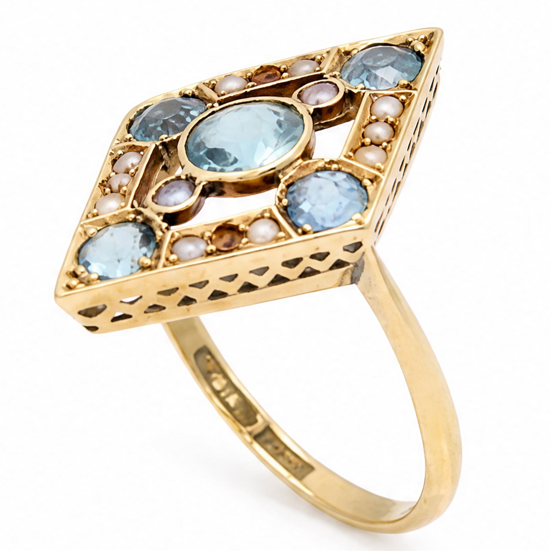 Early 20th century gold blue stone and split pearl diamond shaped ring, five milgrain set round cut stones possibly zircon or aquamarines, with seed pearl surround in a pierced design setting, stamped 18ct 