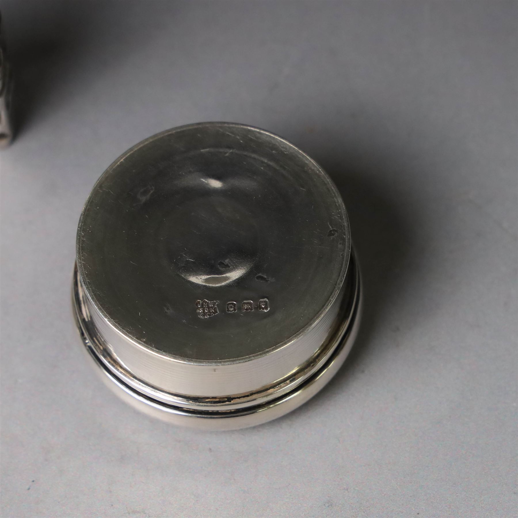 Two early 20th century silver pill/patch boxes, together with two glass perfume bottles with silver overlay and stoppers, all stamped or hallmarked, smallest box D2cm, largest bottle H7cm